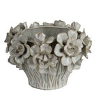Decorative ceramic planter with floral designs on a white background