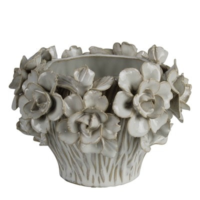 Decorative ceramic planter with floral designs on a white background