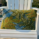 Decorative pillow with floral pattern on a white chair outdoors