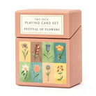 Playing card set packaging with floral designs on a white background