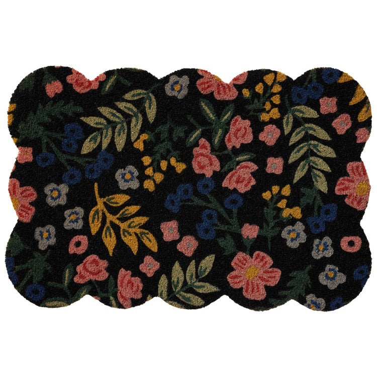 Floral-patterned doormat with pink, blue, and yellow flowers on a black background