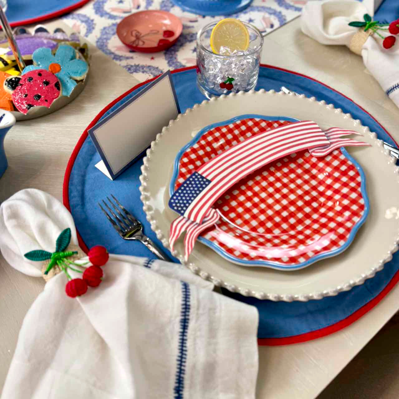 Decorative table setting with red, white, and blue plates and napkins.