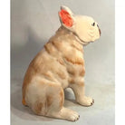 Ceramic sculpture of a dog on a plain background