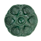 Green ceramic wall art piece with intricate patterns on a white background