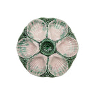 Ceramic oyster plate with shell design on a white background