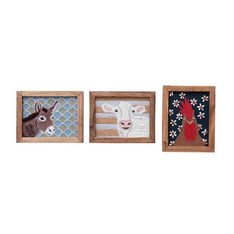 Three framed artworks of a donkey, cow, and deer on a white background