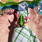 Colorful brooch on a checkered fabric with a blurred background