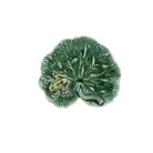 Decorative green leaf-shaped object on a white background