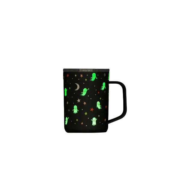 A black mug with a glowing green ghost and star pattern, featuring a black handle and a dark lid, set against a plain white background.
