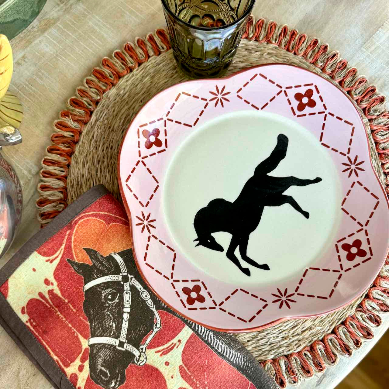 Decorative plate with horse silhouette on a table setting