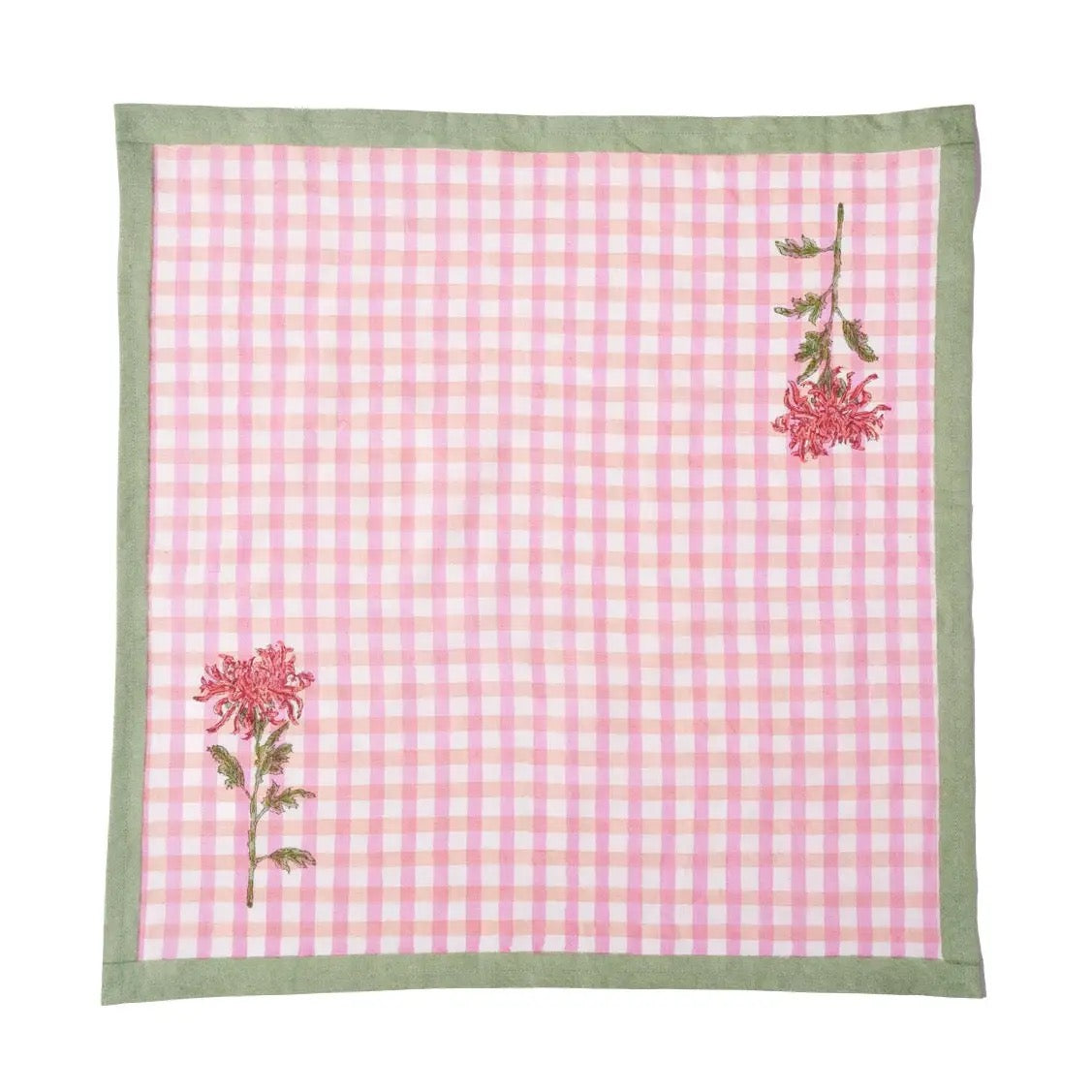 Pink checkered towel with floral designs on a white background