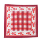 Red and white checkered cloth with lobster patterns on a white background