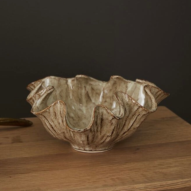 Ceramic bowl with textured surface on a wooden surface