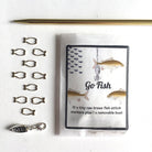 Set of fishing-themed knitting stitch markers with packaging on a white background