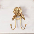 Gold floral wall hook on a white background