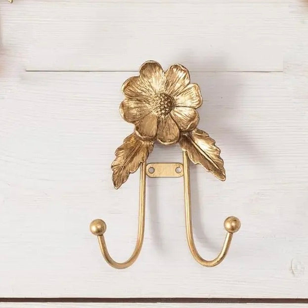 Gold floral wall hook on a white background