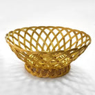A golden metallic woven basket with a lattice pattern and a round base, shown on a white background with soft shadows.