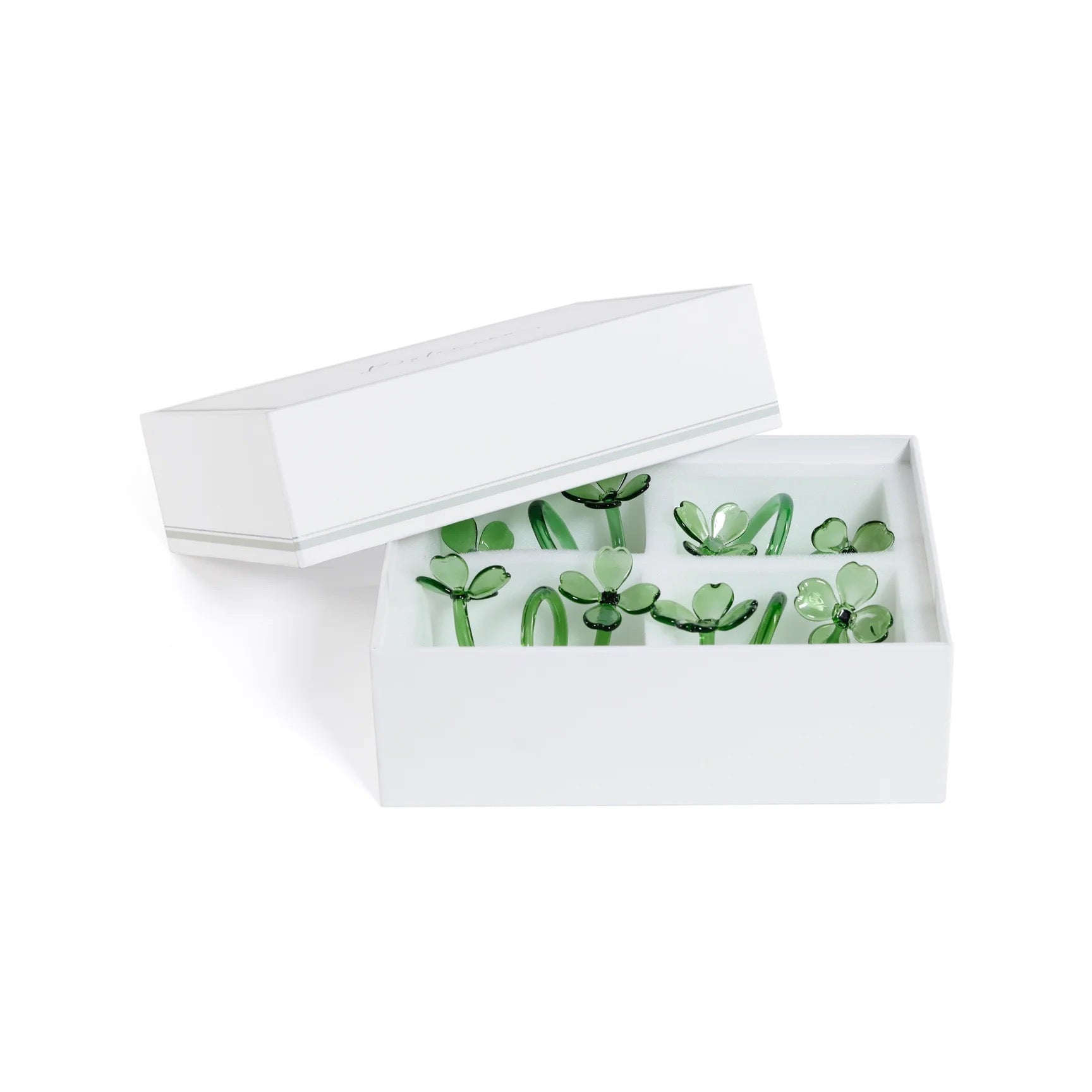 White jewelry box with green floral designs on a white background