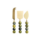 Set of three cheese knives with green bead handles on a white background