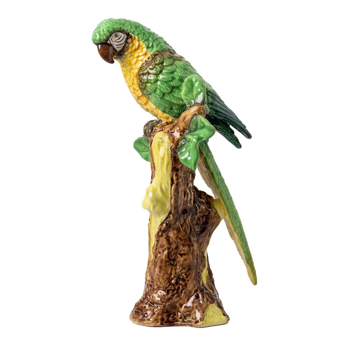 Decorative parrot figurine on a branch with a white background