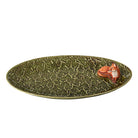 Green ceramic platter with a fox decoration on a white background