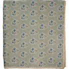 Fabric with blue floral pattern on a green background