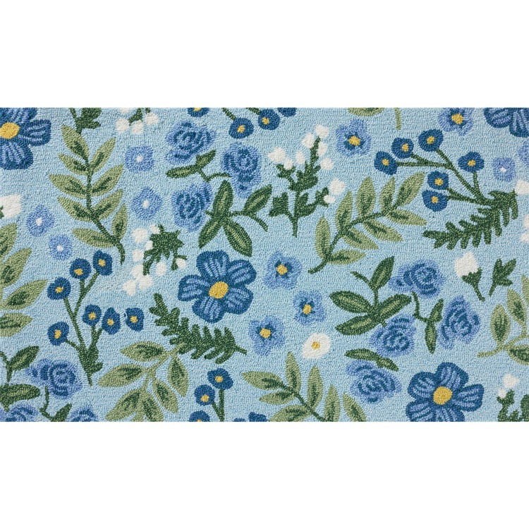 Floral pattern with blue flowers and green leaves on a light blue background