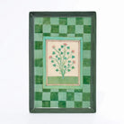 Decorative tray with green mosaic border and floral design in center on a white background