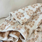Folded fabric with a floral pattern on a neutral background