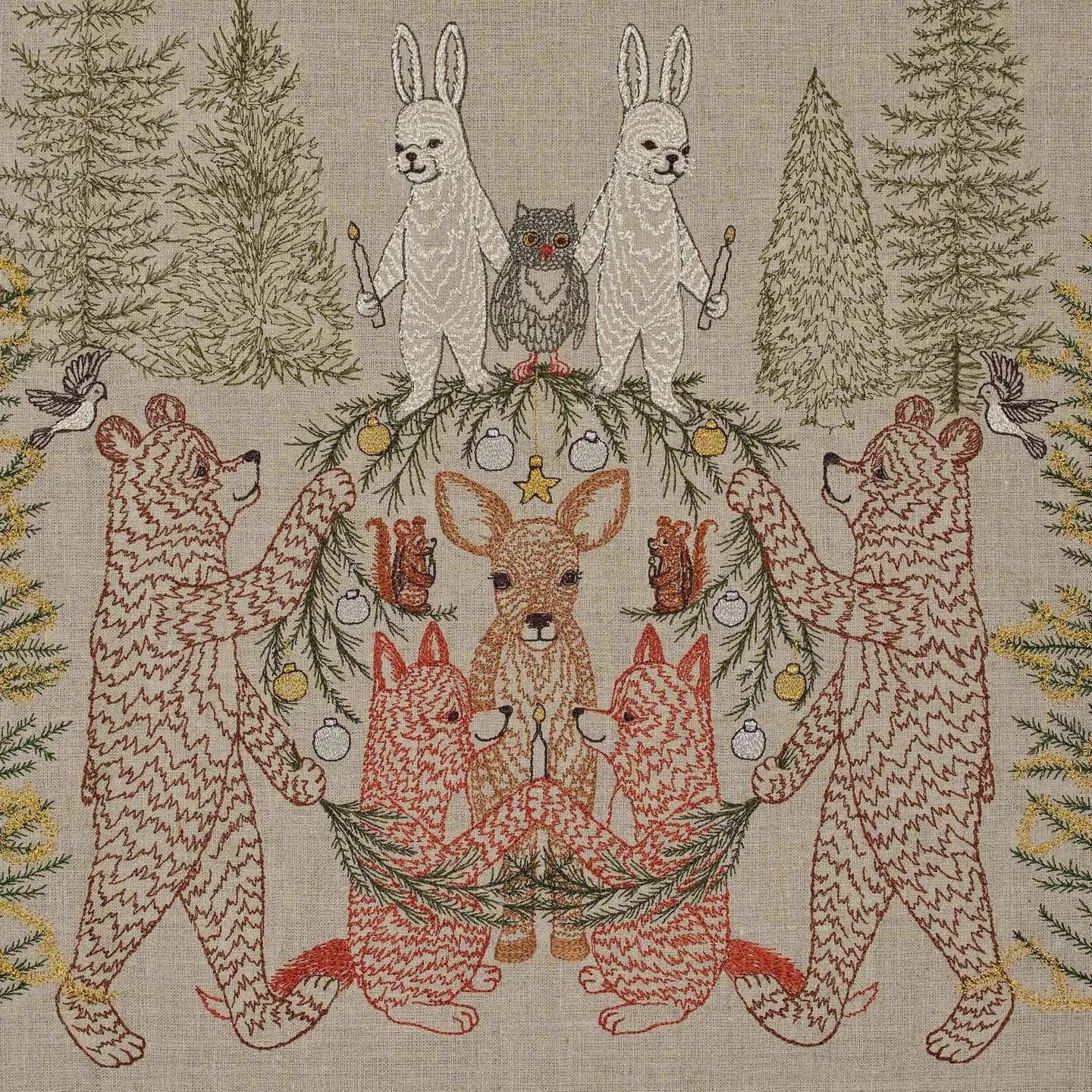 Decorative fabric with embroidered animals in a forest setting