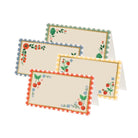 Set of three embroidered place mats with cherry and floral patterns on a white background