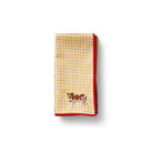 Yellow and red checkered towel with a cow design on a white background
