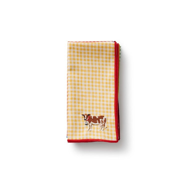 Yellow and red checkered towel with a cow design on a white background