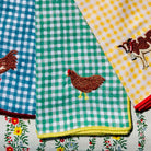 Set of fabric napkins with various patterns including checkered, floral, and animal designs.
