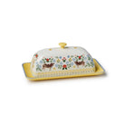 Decorative butter dish with cow and floral pattern on a white background