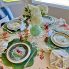 Elegant table setting with floral centerpieces and decorative plates.