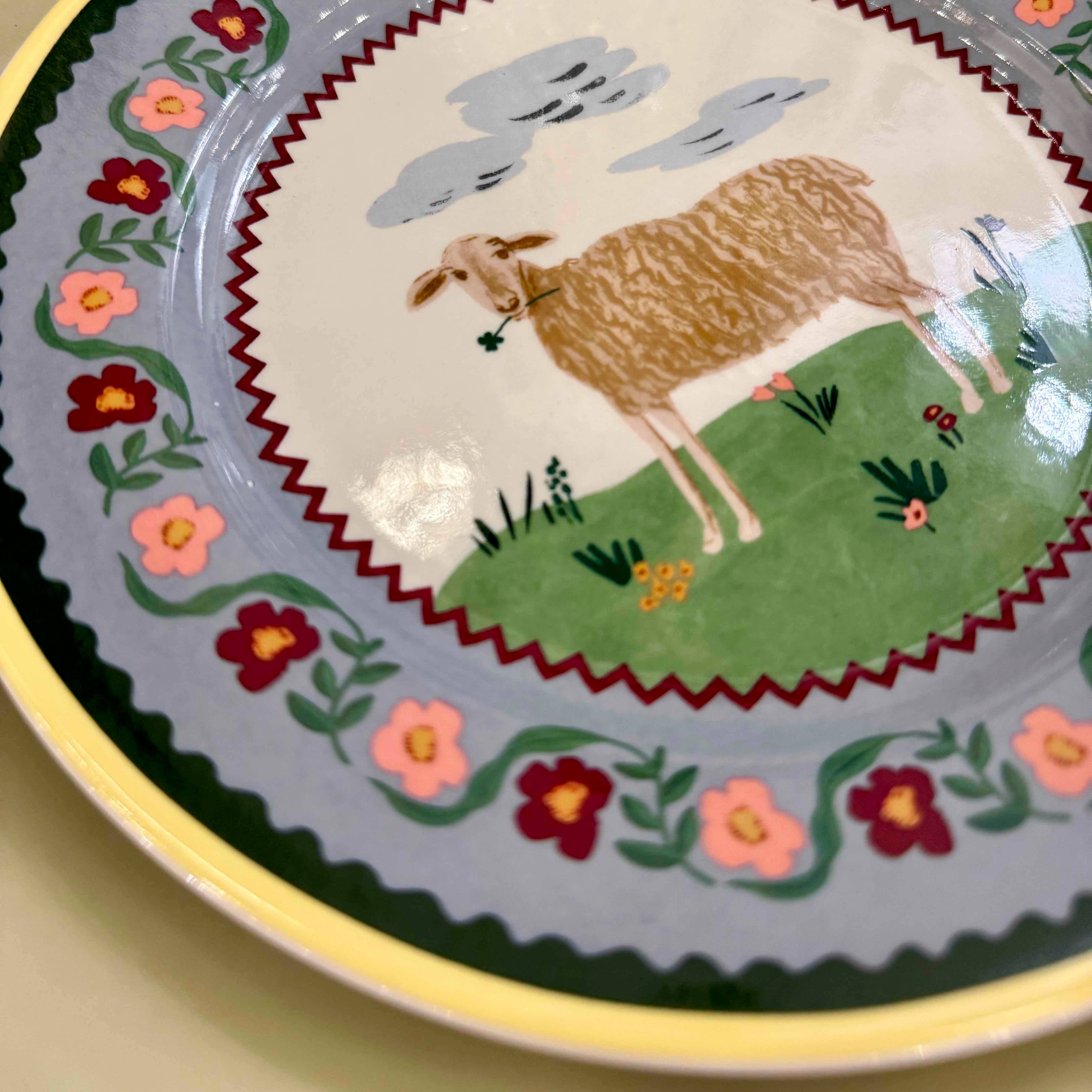Decorative plate with a llama illustration and floral patterns