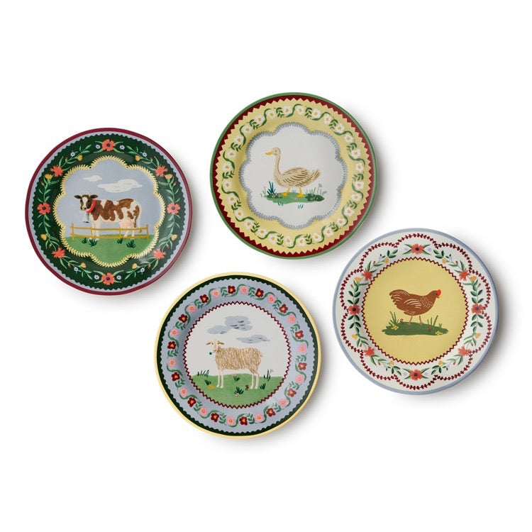 Set of four decorative plates with farm animal illustrations on a white background