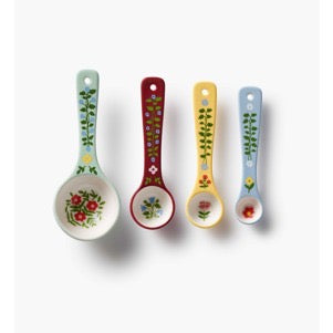 Set of four decorative spoons with floral patterns on a white background