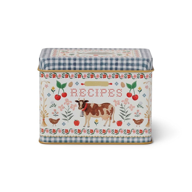 Decorative recipe box with a cow illustration and floral patterns on a white background