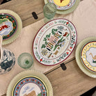 Decorative plates with animal illustrations on a wooden table