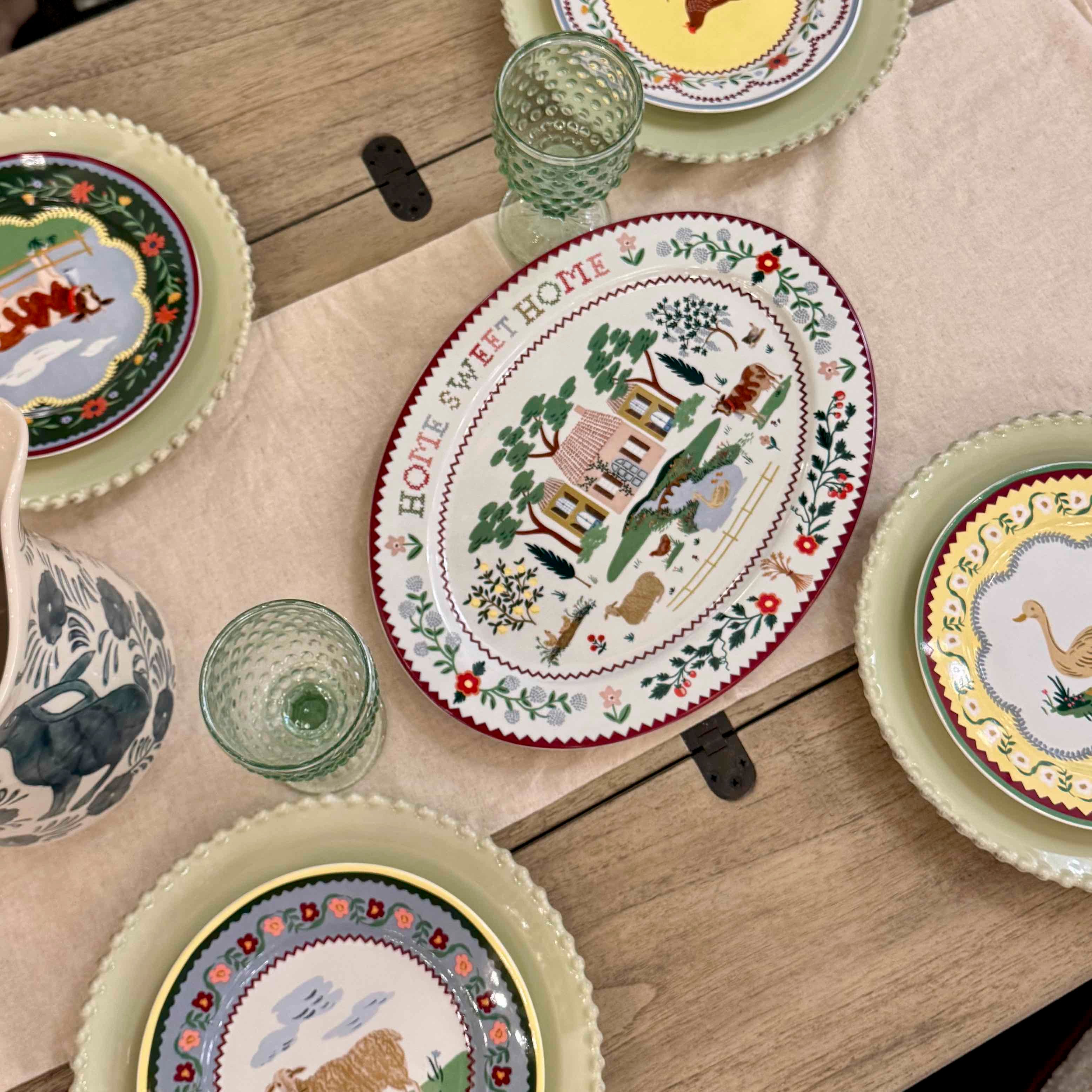 Decorative plates with animal illustrations on a wooden table