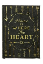 Decorative book with 'Home is where the heart is' text and arrow designs on a black background