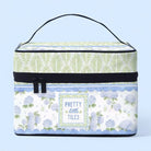Storage box with floral design and 'Pretty Little Tiles' text on a light blue background