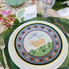Decorative plate with a sheep design on a table setting with a name card.