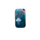 A small rectangular metal tin with a colorful jellyfish illustration, placed on a weathered wooden surface.