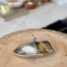 Decorative salt and pepper shaker set on a wooden surface with a blurred background.