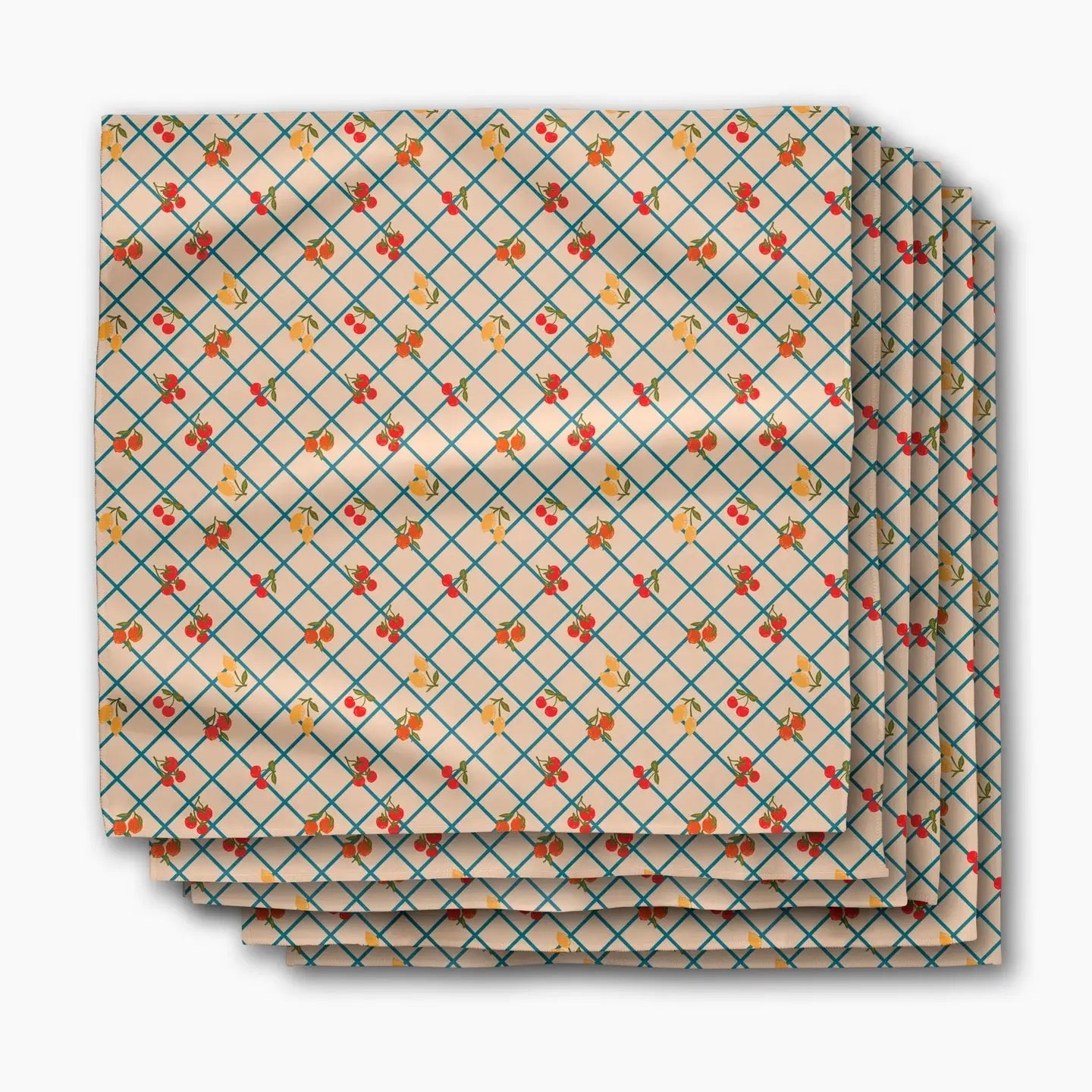 A stack of square paper napkins with a beige background, featuring a teal diamond grid pattern and small red and orange floral motifs.