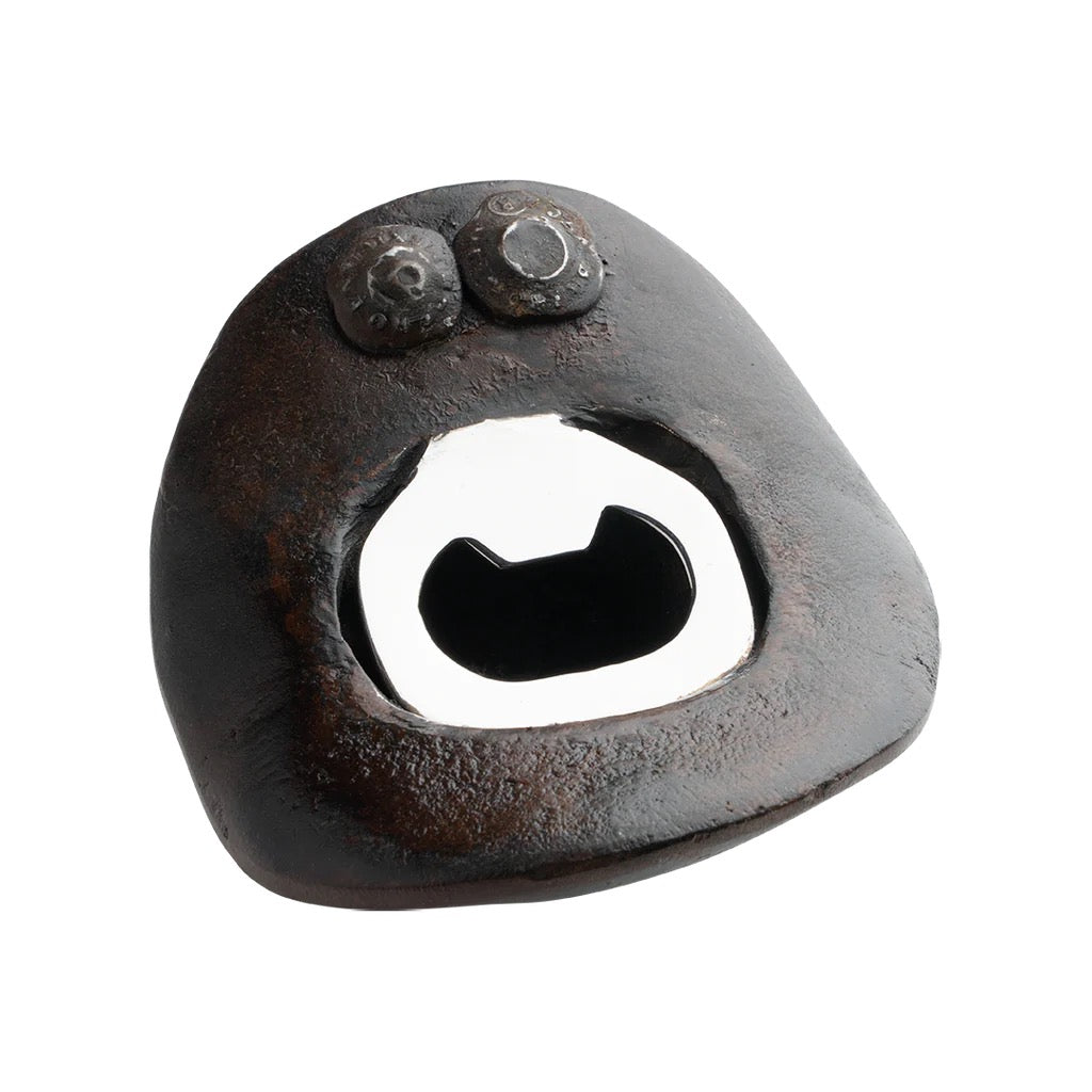 Rustic metal bottle opener on a white background