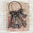 Decorative keychain with keys spelling 'LOVE' on a vintage-style background
